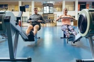 two people working out on exercise equipment 