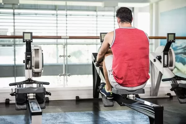 man exercising correctly to prevent a bad rowing machine injury