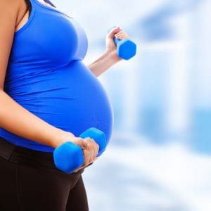 pregnant lady exercising with hand weights