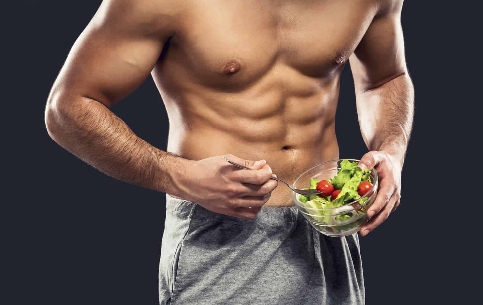 rowing machine workout weight loss results on a male holding a bowl of salad