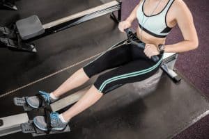 lady working out on rowing machine at the gym