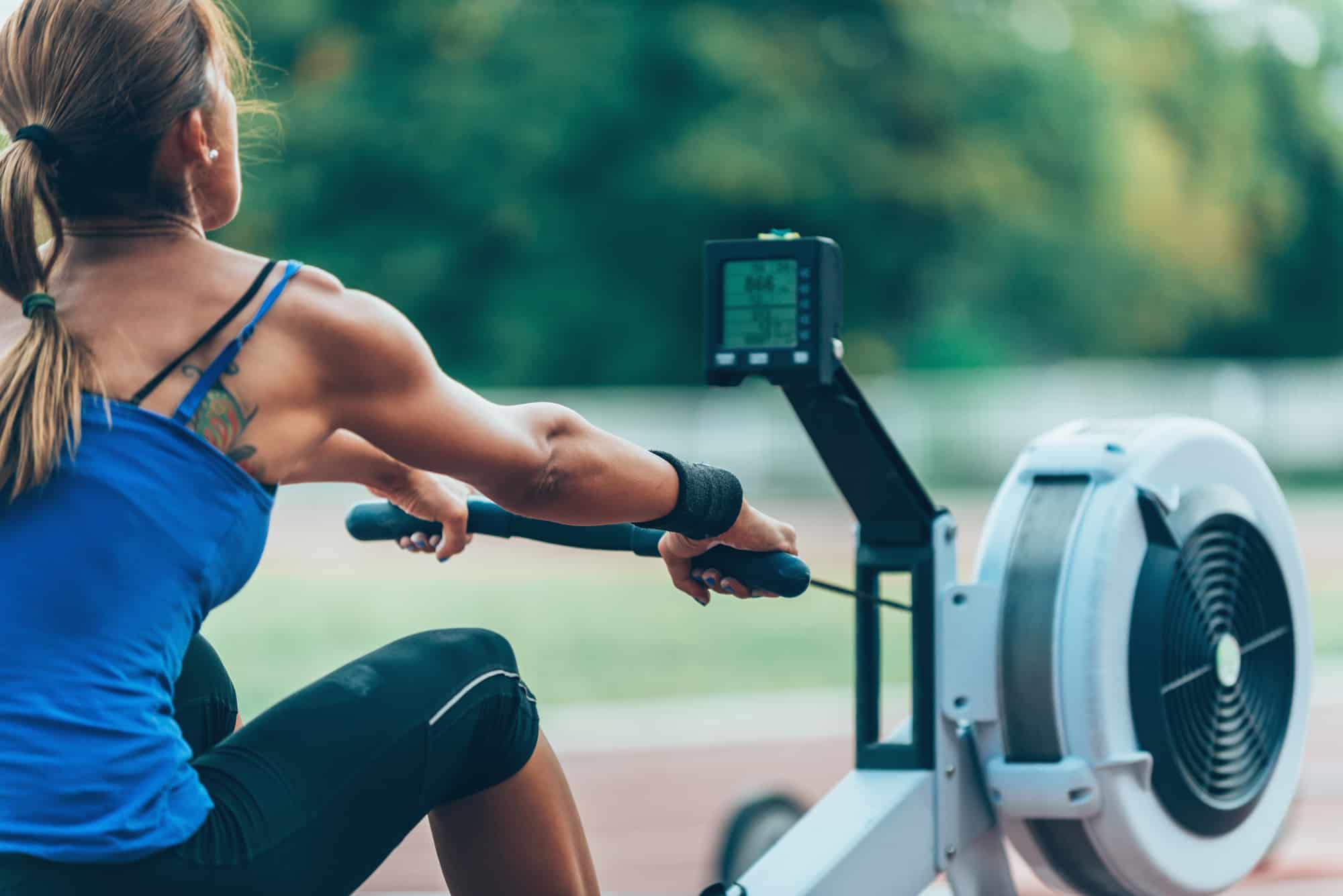 Crossfit Lady exercising on a concept 2 rower outdoors