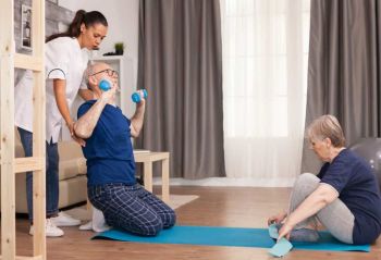 Senior man and lady exercising with Physio