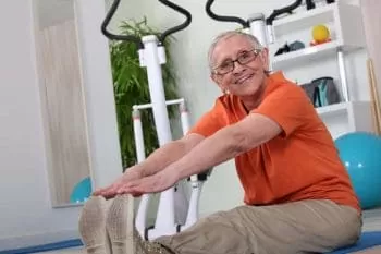 elderly man touching his toes