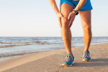 man holding his painful knee