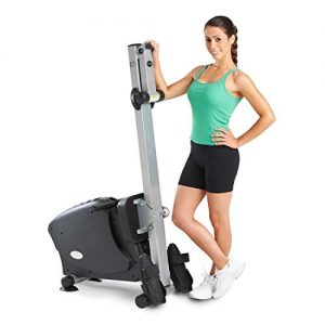 lady standing next to LifeSpan RW1000 rowing machine folded