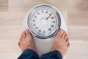 man standing on a weighing scale