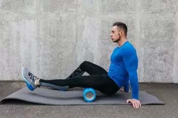 leg stretching on a yoga mat