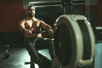 man exercising on a rowing machine