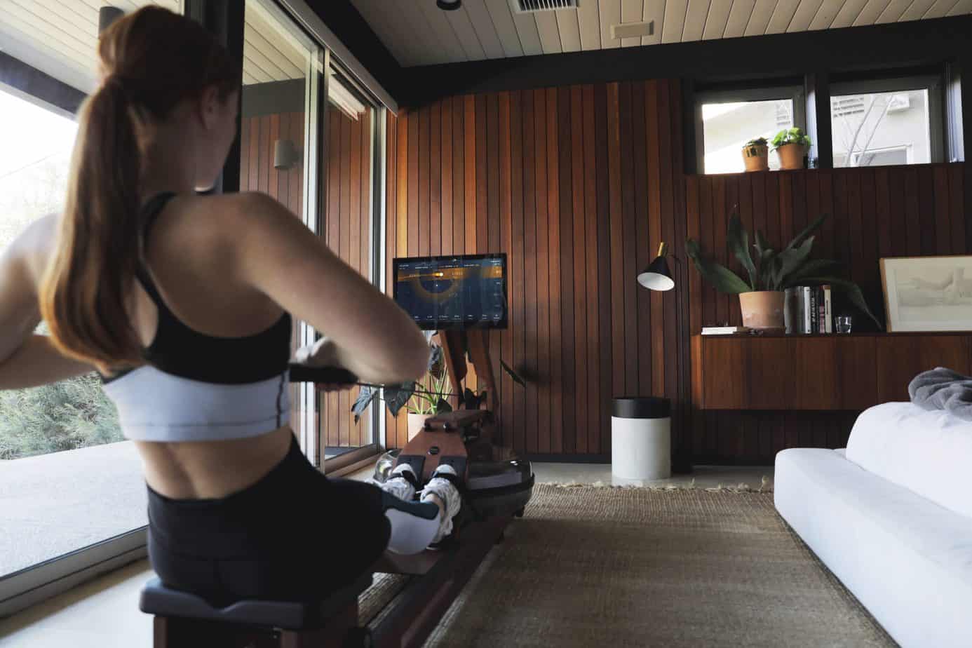 Lady at home exercising on Ergatta Rowing Machine