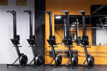 5 rowing machines stored in a line after use