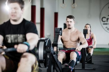 men rowing at gym 