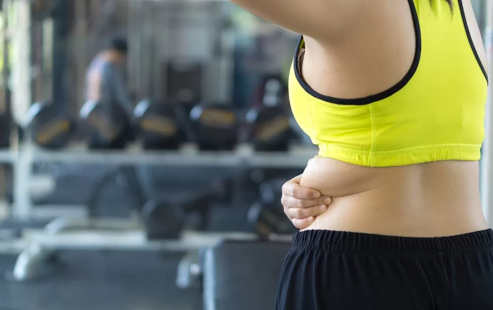 lady doing gym exercises for back fat