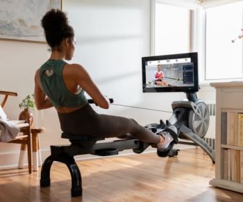 lady exercising on nordictrack rower with on-screen trainer