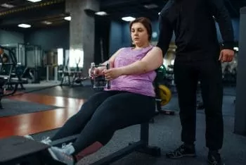 woman with trainer at the gym