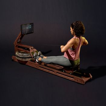 woman using wooden rowing machine