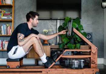 man using Ergatta Wooden Water Rower