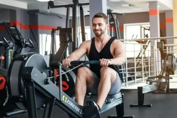 man showing correct rowing machine posture