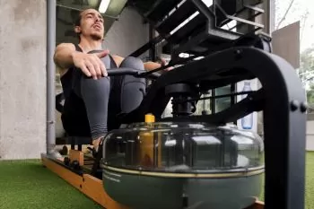 man using a foldable water rower