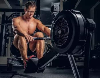 A man doing workouts on a back with power exercise machine.