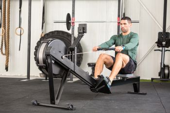 man exercising on a rower after bike workout