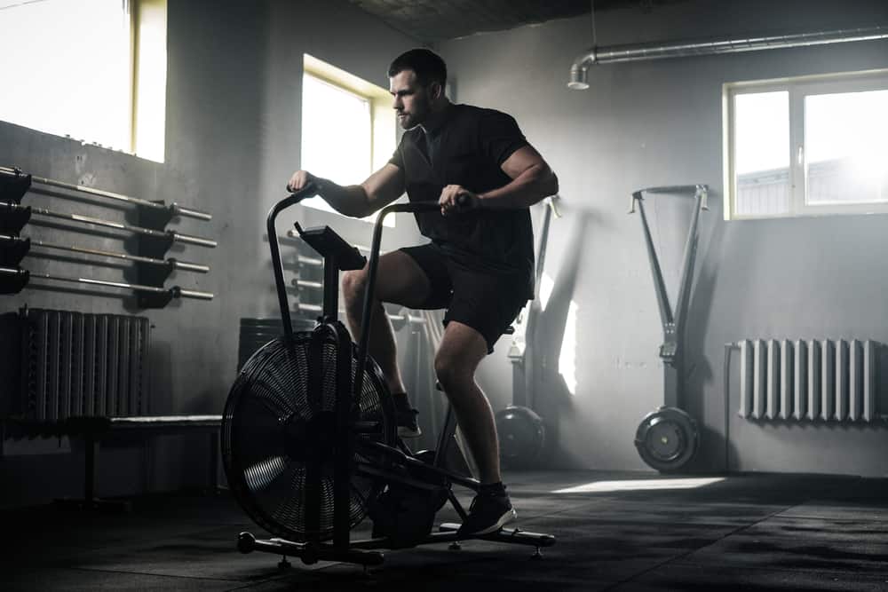 rower training on a bike at the gym