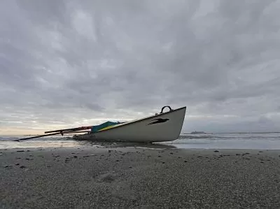 a boat docked on a sandy shore