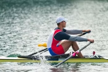 man showing what is a scull boat