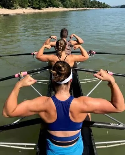 female heavyweight rowers flexing their muscles