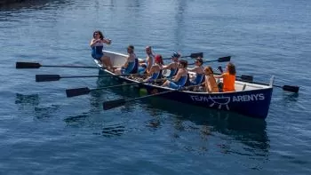 team of young rowers earning new rowing technique 