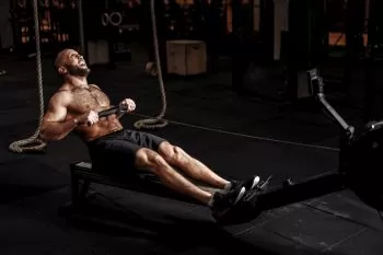 man at crossfit doing resistance workout on rower 