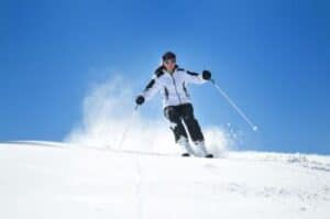 lady skiing in the snow on a hill