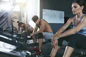 People working out on a rowing machine