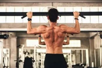 man at gym doing rowing strength training program