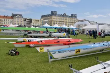 crew boats sitting on the grass