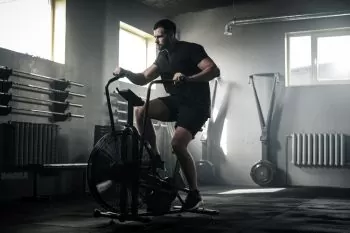 Man exercising at the gym on a bike 