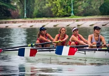 female rowing team competing in a race