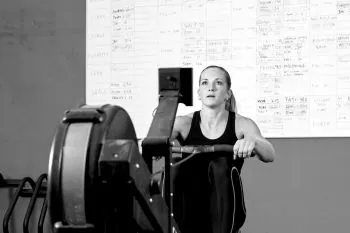 lady rowing on a erg working out