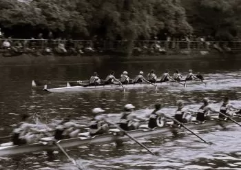 Team of rowers racing on the water at a regatta
