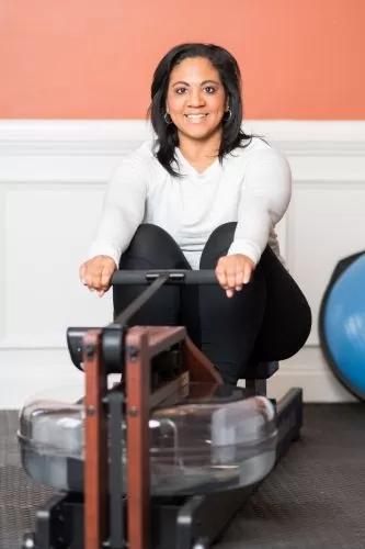 Woman exercising on a water rower