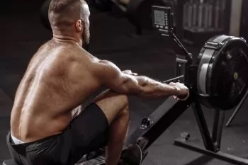man working out on rowing machine