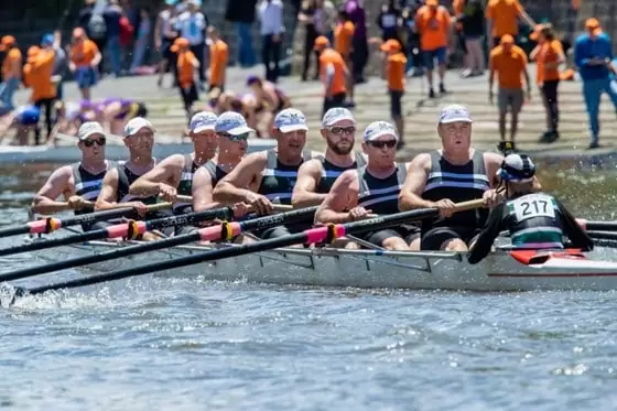 Action shot of a men's Eight sweep team in a rowing competition