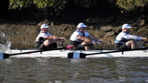 A sweep rowing team wearing a white uniform