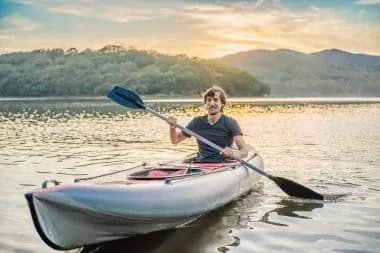 A man kayaking on a lake