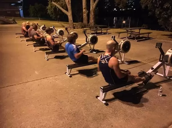 Men's rowing team training on Concept 2 rowing machines