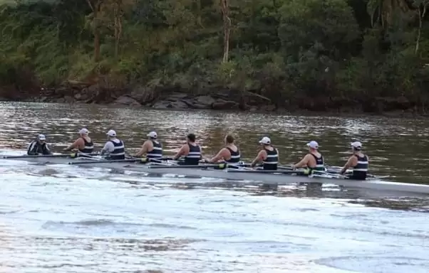 Men's 8 rowing team training with their cox