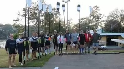 Group of rowers holding their oars