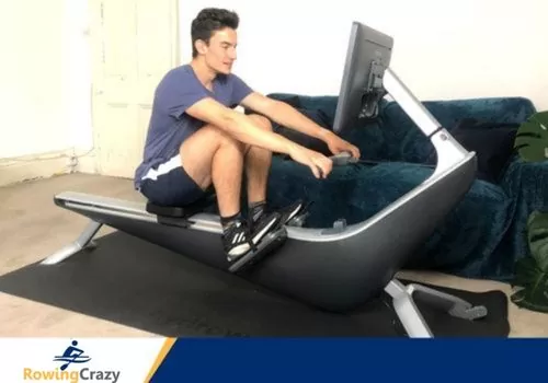 Max Secunda working out on a Hydrow Rower, Side View
