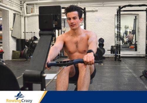 Max Secunda working out in a gym on a Concept 2 rowing machine