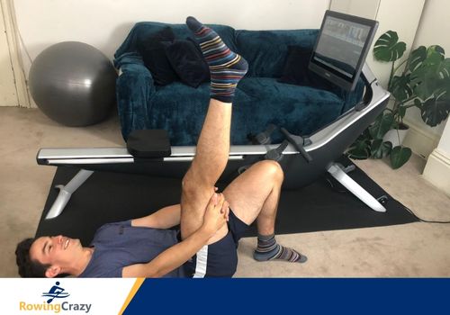 Max Secunda doing leg stretches before doing a rowing workout